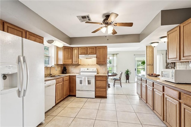 425 Eden Isles Blvd, Slidell, LA 70458 - kitchen with white appliances, tasteful backsplash, under cabinet range hood, a ceiling fan, and light tile patterned flooring