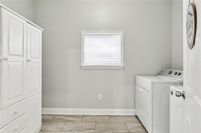 1614 River Oaks Dr, New Orleans, LA 70131 - washroom featuring washing machine and clothes dryer, cabinet space, and light marble finish flooring