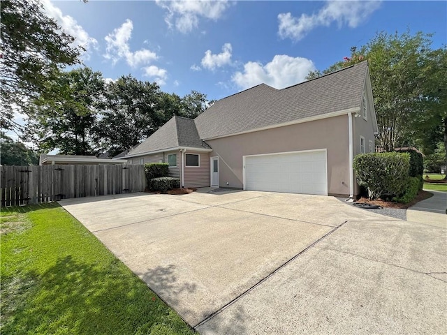 207 Hidden Springs Ln, Covington, LA 70433 - view of front of home featuring concrete driveway, an attached garage, stucco siding, and a shingled roof