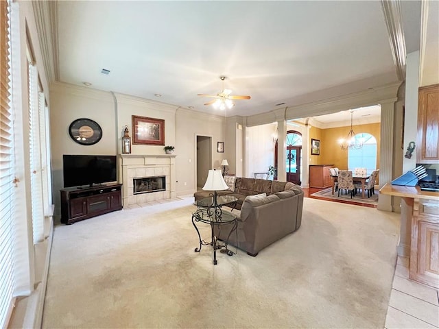 207 Hidden Springs Ln, Covington, LA 70433 - living area featuring a tile fireplace, light carpet, crown molding, a chandelier, and ceiling fan