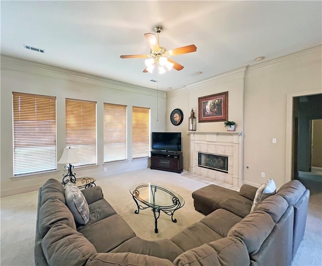 207 Hidden Springs Ln, Covington, LA 70433 - living room with carpet flooring, ceiling fan, ornamental molding, a tiled fireplace, and healthy amount of natural light