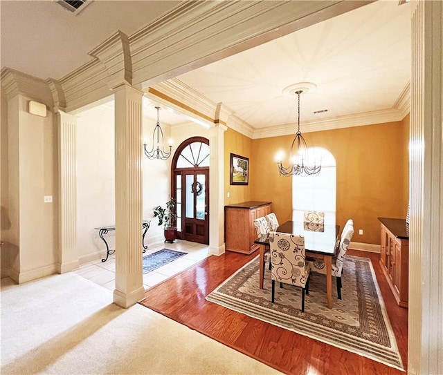 207 Hidden Springs Ln, Covington, LA 70433 - dining space with a chandelier, crown molding, ornate columns, and wood finished floors