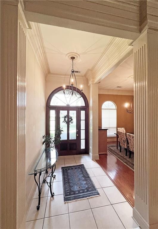 207 Hidden Springs Ln, Covington, LA 70433 - foyer entrance with ornamental molding, light tile patterned floors, and a chandelier