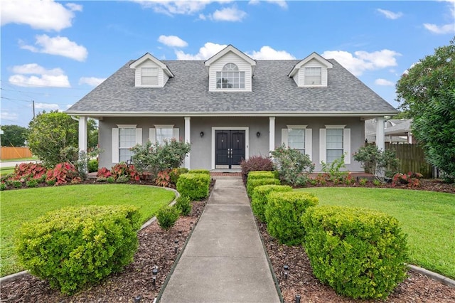 1 Platt St, Kenner, LA 70065 - cape cod house featuring roof with shingles, stucco siding, and a porch