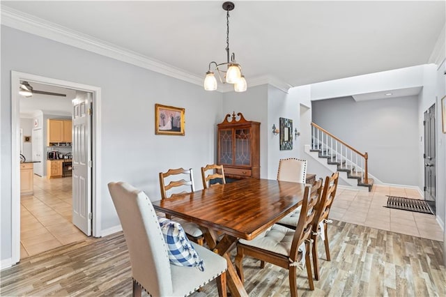 1 Platt St, Kenner, LA 70065 - dining space with stairs, crown molding, light wood-type flooring, a chandelier, and ceiling fan