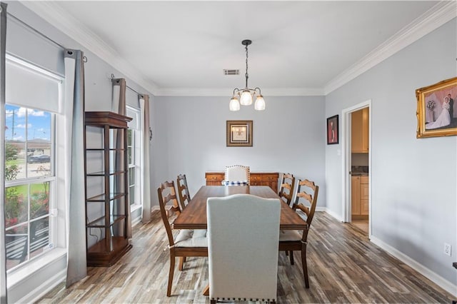 1 Platt St, Kenner, LA 70065 - dining space featuring wood finished floors, ornamental molding, and a chandelier