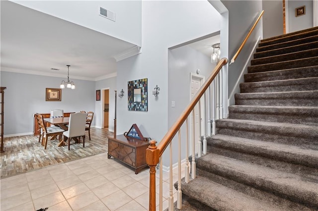 1 Platt St, Kenner, LA 70065 - stairs with crown molding, a chandelier, and tile patterned floors