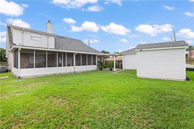 1 Platt St, Kenner, LA 70065 - back of property featuring a sunroom, a chimney, and a yard