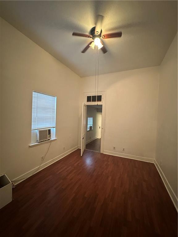 2620-22 Philip St, New Orleans, LA 70113 - empty room featuring cooling unit, ceiling fan, dark wood-style floors, and plenty of natural light
