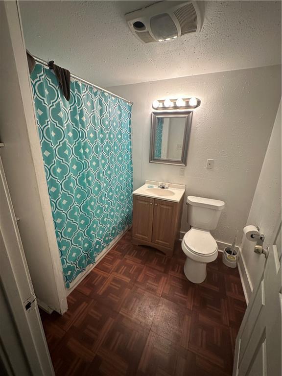 2620-22 Philip St, New Orleans, LA 70113 - bathroom featuring vanity, a textured ceiling, and curtained shower