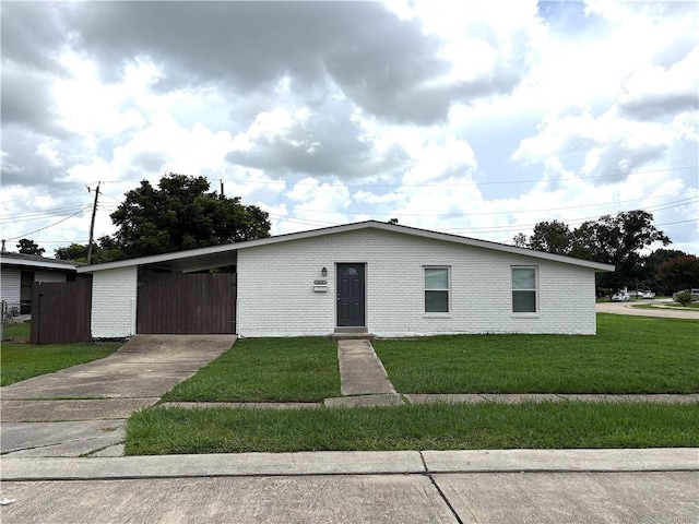 2128 Dupont Dr, Gretna, LA 70056 - view of front facade featuring an attached carport, brick siding, and driveway