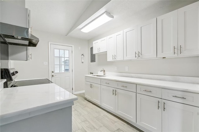 2128 Dupont Dr, Gretna, LA 70056 - kitchen with electric range, light countertops, wall chimney range hood, and white cabinets