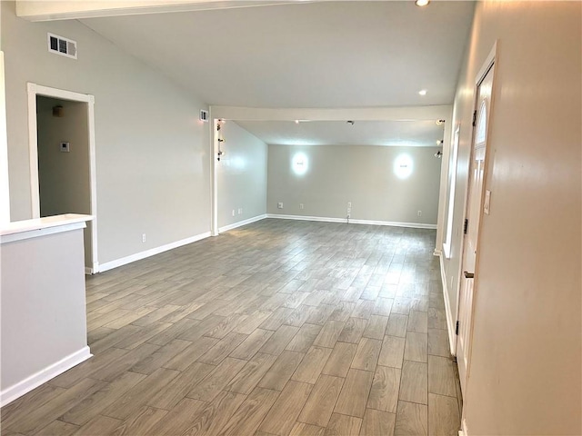 2128 Dupont Dr, Gretna, LA 70056 - unfurnished room with wood finished floors, lofted ceiling, and recessed lighting