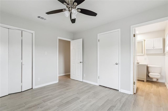 2128 Dupont Dr, Gretna, LA 70056 - unfurnished bedroom with light wood finished floors, ensuite bath, ceiling fan, and a closet