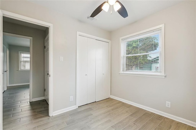2128 Dupont Dr, Gretna, LA 70056 - unfurnished bedroom featuring light wood-style flooring, a closet, and a ceiling fan