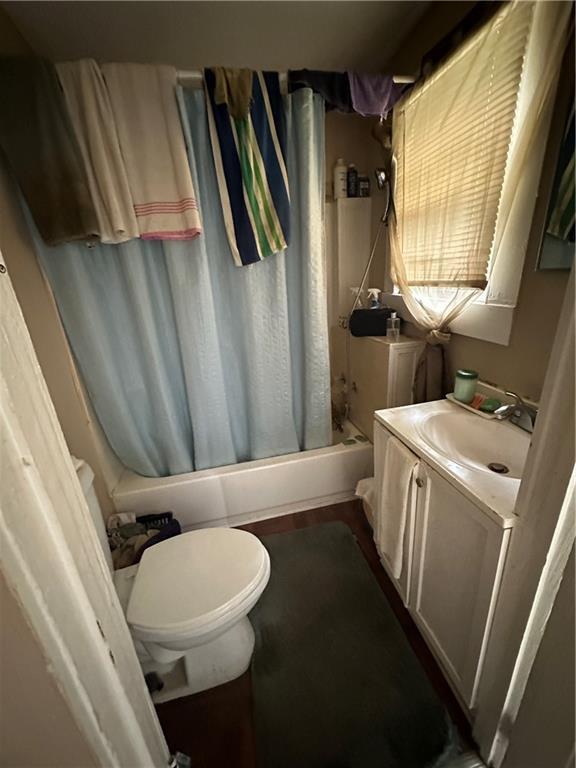 2217 Willow St, New Orleans, LA 70113 - bathroom with shower / bath combo with shower curtain and vanity