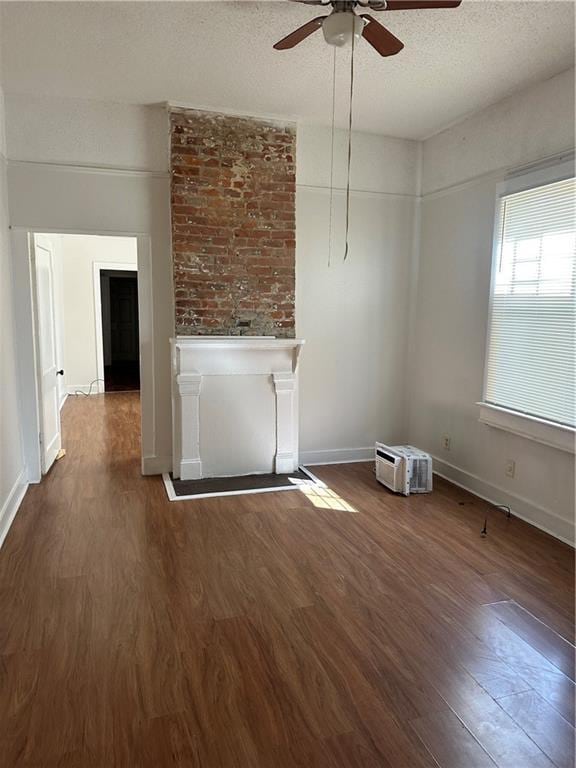 2217 Willow St, New Orleans, LA 70113 - unfurnished living room with wood finished floors, a ceiling fan, and a textured ceiling