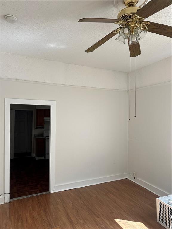 2217 Willow St, New Orleans, LA 70113 - spare room featuring wood finished floors, a ceiling fan, a smoke detector, and a textured ceiling