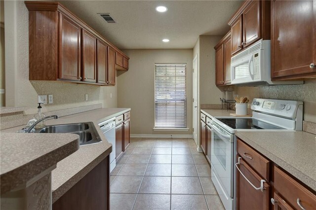 2523 Robin St, Slidell, LA 70460 - kitchen featuring white appliances, recessed lighting, light countertops, and light tile patterned flooring