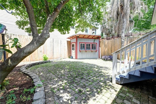 4005-4007 Camp St, New Orleans, LA 70115 - fenced backyard with an outdoor structure and a patio