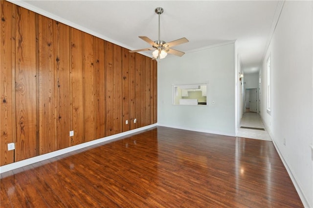 922 Lafayette St, Gretna, LA 70053 - unfurnished living room featuring wood finished floors, ceiling fan, crown molding, and wooden walls