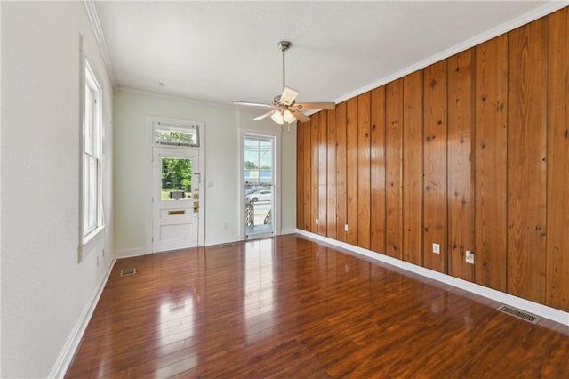 922 Lafayette St, Gretna, LA 70053 - empty room featuring wood finished floors, ornamental molding, a ceiling fan, and wood walls