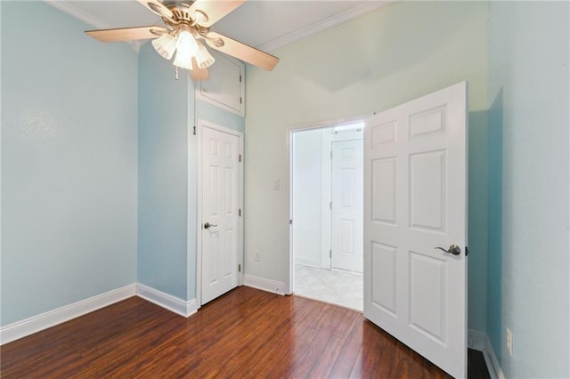 922 Lafayette St, Gretna, LA 70053 - unfurnished bedroom with dark wood-style floors, crown molding, and ceiling fan