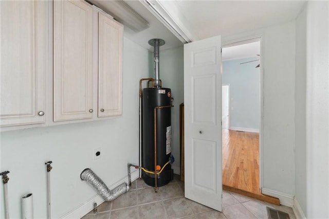 922 Lafayette St, Gretna, LA 70053 - washroom featuring water heater, cabinet space, hookup for an electric dryer, and light tile patterned flooring