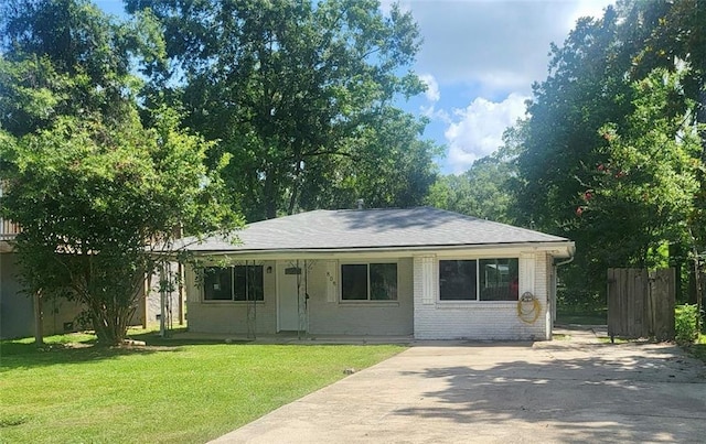 808 Pine Tree St, Slidell, LA 70458 - view of front facade with a front yard, driveway, roof with shingles, and brick siding