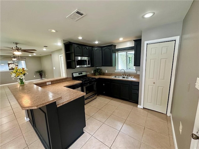 808 Pine Tree St, Slidell, LA 70458 - kitchen featuring appliances with stainless steel finishes, a peninsula, light tile patterned flooring, open shelves, and recessed lighting