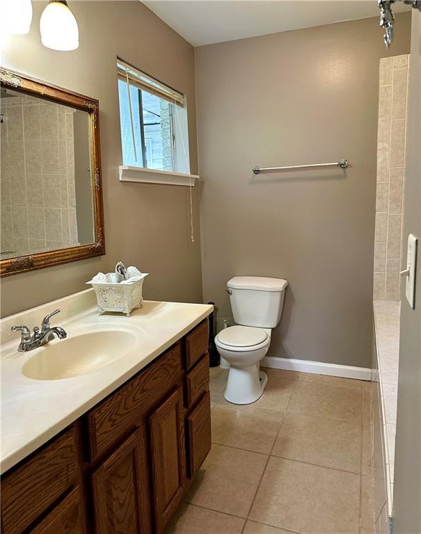 808 Pine Tree St, Slidell, LA 70458 - bathroom featuring vanity, tile patterned flooring, and a tile shower