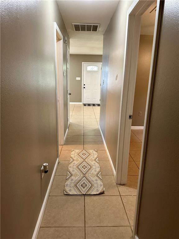 808 Pine Tree St, Slidell, LA 70458 - hall with light tile patterned flooring and baseboards
