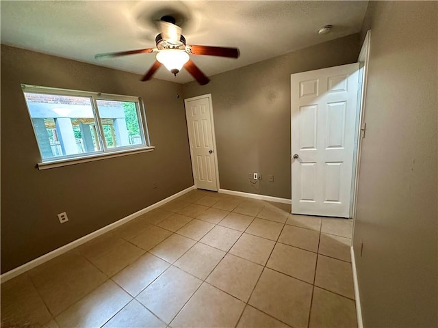 808 Pine Tree St, Slidell, LA 70458 - empty room with a ceiling fan, light tile patterned flooring, and a smoke detector