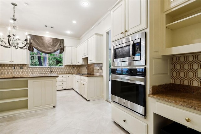 104 Acadian Ln, Mandeville, LA 70471 - kitchen featuring stainless steel appliances, open shelves, a chandelier, backsplash, and ornamental molding