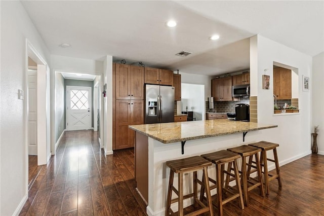 124 Brentwood Dr, Belle Chasse, LA 70037 - kitchen featuring stainless steel appliances, dark wood-style floors, decorative backsplash, a peninsula, and recessed lighting