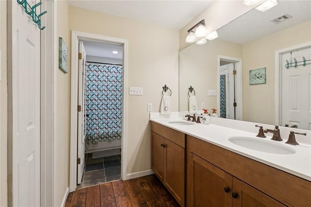 124 Brentwood Dr, Belle Chasse, LA 70037 - full bath with double vanity, wood finished floors, and a shower with curtain