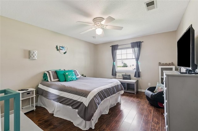 124 Brentwood Dr, Belle Chasse, LA 70037 - bedroom with dark wood-type flooring, ceiling fan, and a textured ceiling