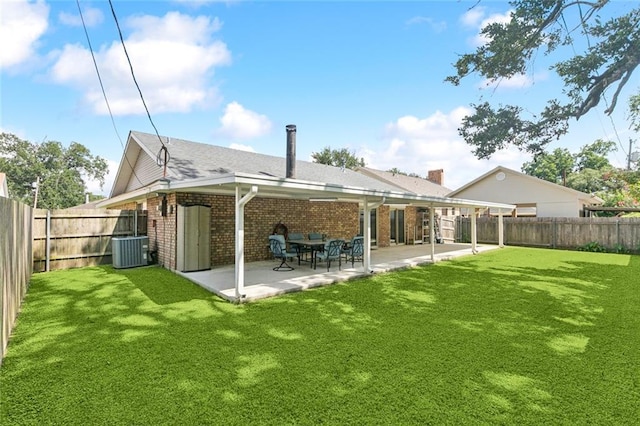124 Brentwood Dr, Belle Chasse, LA 70037 - back of property featuring brick siding, a fenced backyard, and a patio