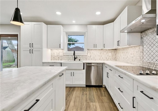 1424 Pecan Ave, Metairie, LA 70001 - kitchen featuring stainless steel dishwasher, wall chimney range hood, black electric stovetop, light countertops, and recessed lighting