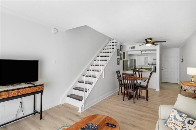 3805 Houma Blvd Unit A243, Metairie, LA 70006 - living area with stairway, wood finished floors, and a ceiling fan