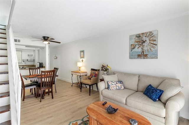 3805 Houma Blvd Unit A243, Metairie, LA 70006 - living area with stairs, light wood-style floors, and a ceiling fan