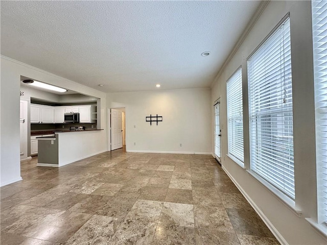 350 Emerald Forest Blvd Unit 5105, Covington, LA 70433 - unfurnished living room featuring a textured ceiling, light stone finish floors, recessed lighting, and ornamental molding