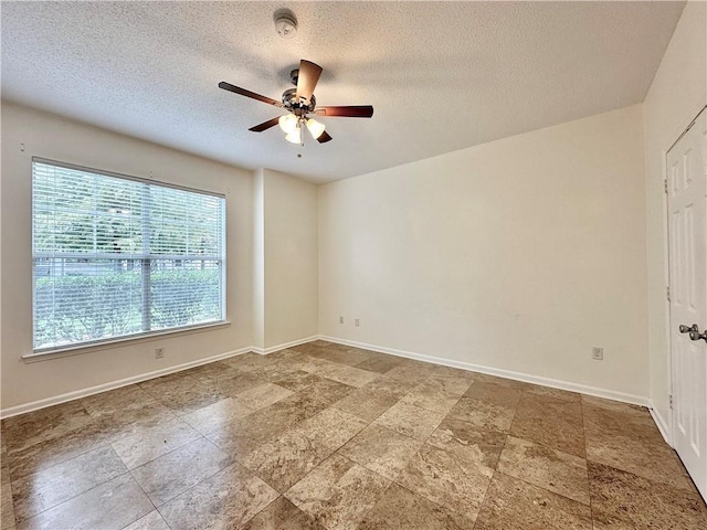350 Emerald Forest Blvd Unit 5105, Covington, LA 70433 - unfurnished room featuring ceiling fan, a smoke detector, a textured ceiling, and stone finish floors