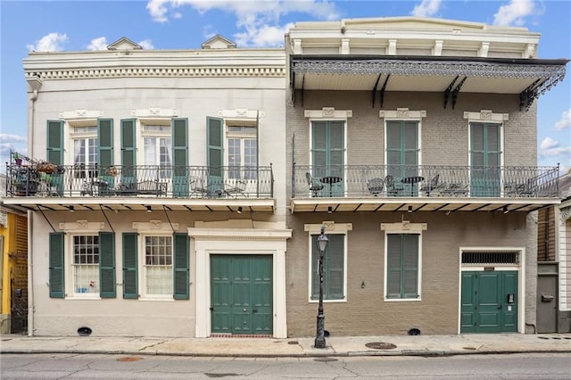 1225 Bourbon St Unit F, New Orleans, LA 70116 - townhome / multi-family property with brick siding and a balcony