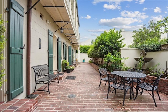 1225 Bourbon St Unit F, New Orleans, LA 70116 - fenced backyard featuring a patio area and outdoor dining area