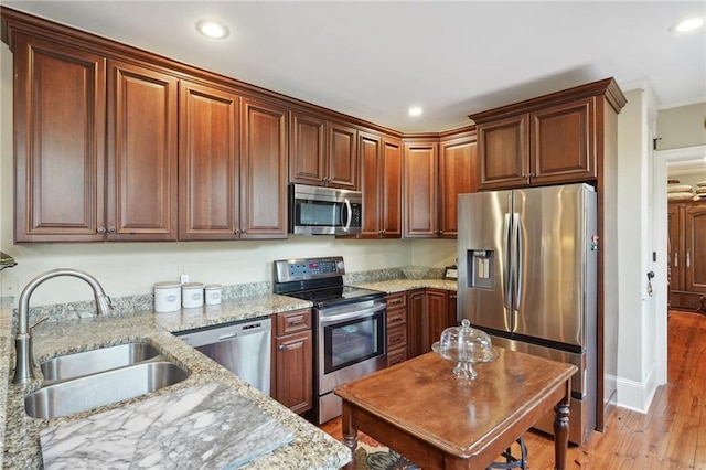 1225 Bourbon St Unit F, New Orleans, LA 70116 - kitchen with stainless steel appliances, recessed lighting, light wood-type flooring, light stone countertops, and ornamental molding
