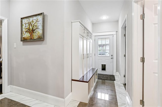 5024 S Claiborne Ave, New Orleans, LA 70125 - mudroom featuring marble look tiles and baseboards