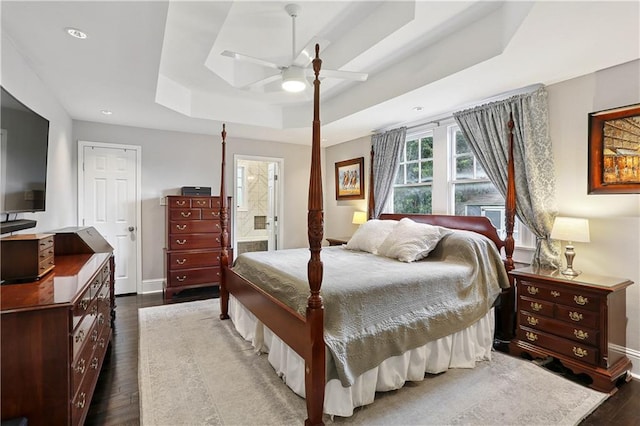 5024 S Claiborne Ave, New Orleans, LA 70125 - bedroom featuring a tray ceiling, dark wood finished floors, recessed lighting, connected bathroom, and a ceiling fan