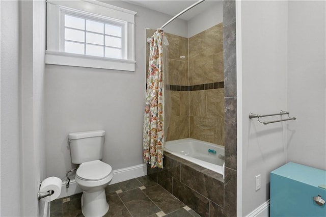 5024 S Claiborne Ave, New Orleans, LA 70125 - bathroom featuring baseboards and tiled shower / bath combo