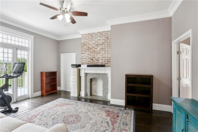 5024 S Claiborne Ave, New Orleans, LA 70125 - living room with a large fireplace, wood finished floors, a ceiling fan, and ornamental molding